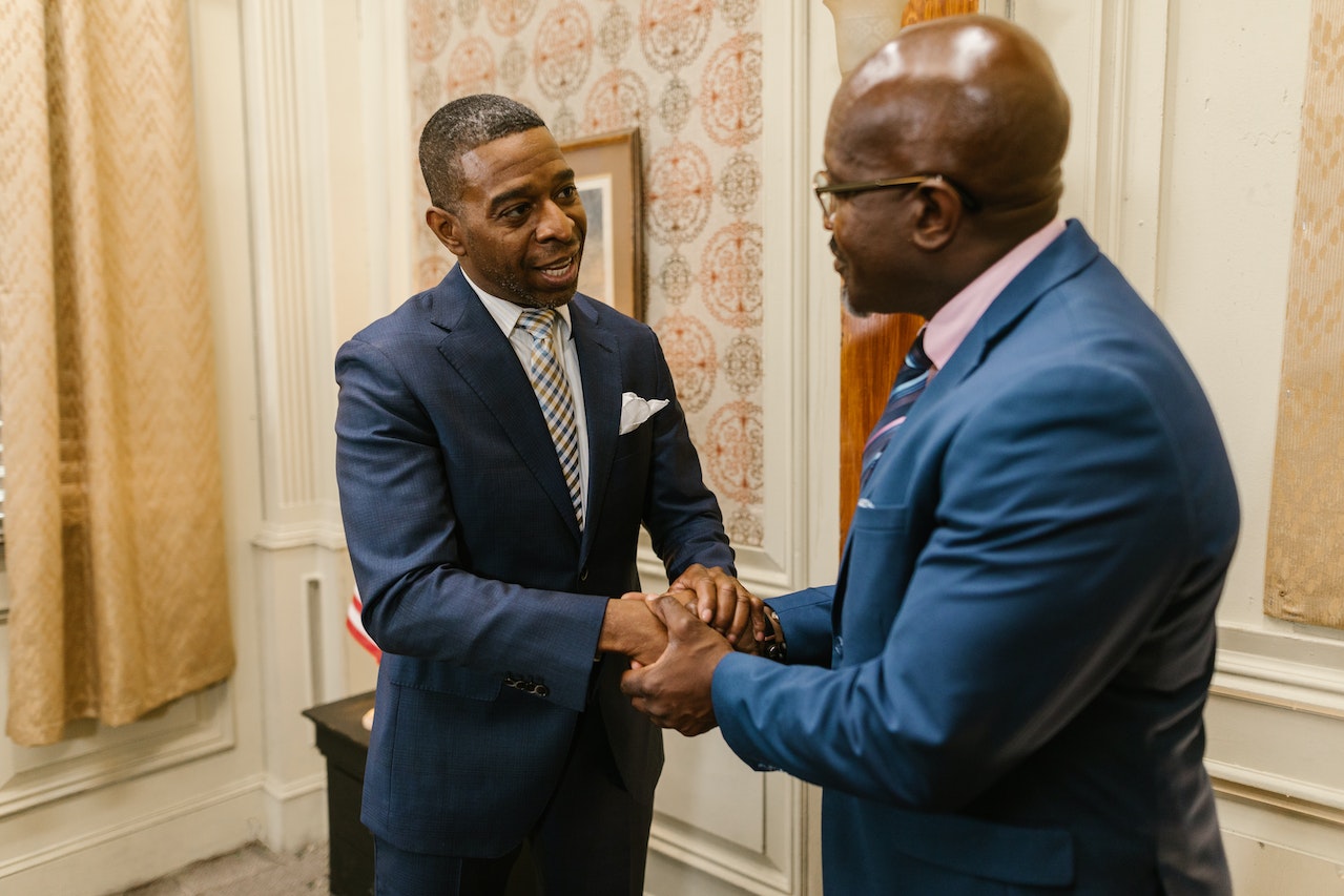 two-business-men-shaking-hands-after-work-meeting-at-office-negotiation-strategies