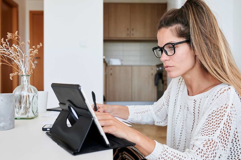 Woman-Using-Table-To-Take-Online-Test-how-to-improve-emotional-intelligence